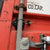 Close-up of a battery-powered GPS tracker attached to a shipping container door, used for monitoring and securing cargo in transit.
