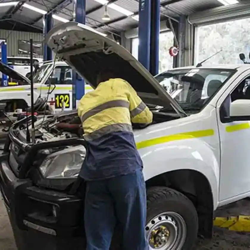 Mechanic servicing a fleet vehicle in a workshop, representing GPS fleet tracking solutions for construction and mining industries in Australia.