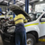 Mechanic servicing a fleet vehicle in a workshop, representing GPS fleet tracking solutions for construction and mining industries in Australia.