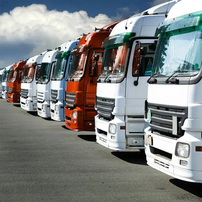 Row of parked trucks in a fleet yard, representing GPS tracking and fleet management solutions for transport and logistics in Perth.