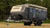 Off-road caravan parked in a grassy clearing, representing GPS tracking solutions for caravans, RVs, trailers, and off-grid travel.