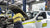 Mechanic working on a fleet vehicle in a workshop, representing installation and maintenance of hardwired GPS tracking systems for commercial fleets in Australia.
