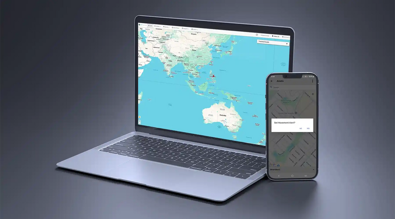 Laptop displaying Keep Track GPS tracking software with Australia map and smartphone showing movement alert setup screen, demonstrating real-time asset tracking via web and mobile app.