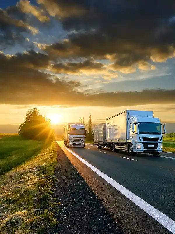 Fleet trucks on Australian highway at sunrise, tracked with Keep Track GPS fleet management and vehicle tracking solutions in Perth and nationwide