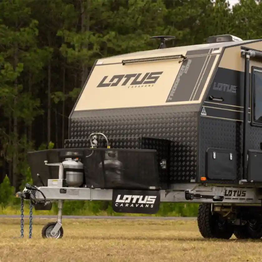 Off-road caravan parked in a grassy clearing, representing GPS tracking solutions for caravans, RVs, trailers, and off-grid travel.